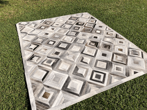 Open image in slideshow, Cowhide - Chevron Diamond Patchwork Rug
