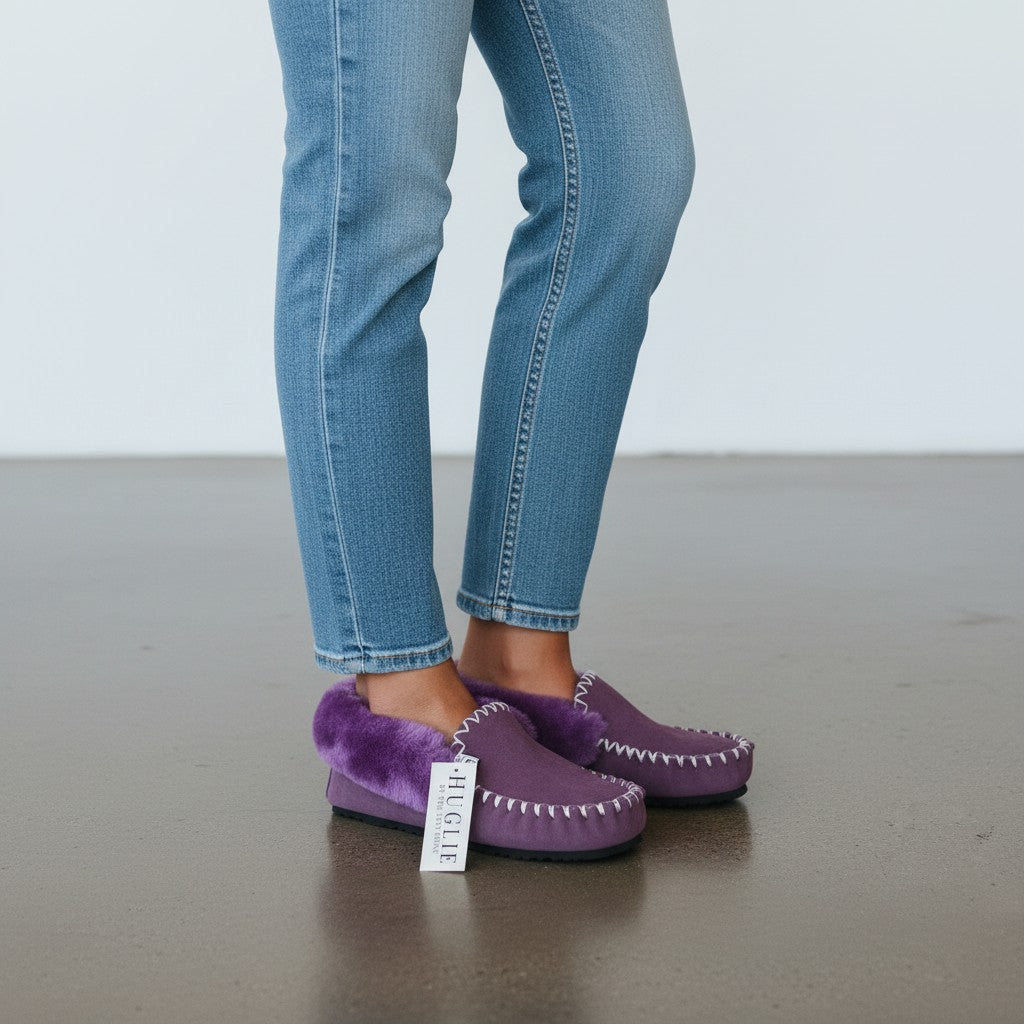 The Skin Thing HUGLIE purple sheepskin moccasins with white stitching and fluffy lining. Lightweight EVA sole.