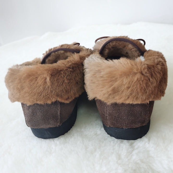 The Skin Thing brown suede kangaroo moccasins with fluffy fur trim and wool lining. Slip-on style.