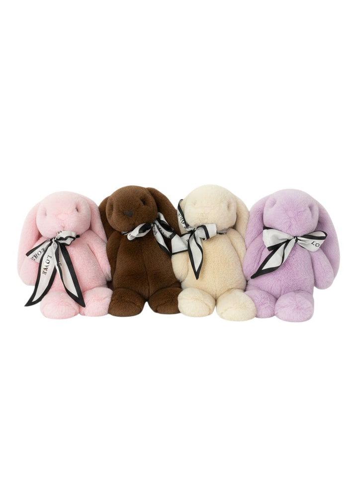 The Skin Thing Rex Rabbit plush toys in pink, brown, cream, and lavender, made from genuine Rex Rabbit fur, tied with a black and white ribbon.